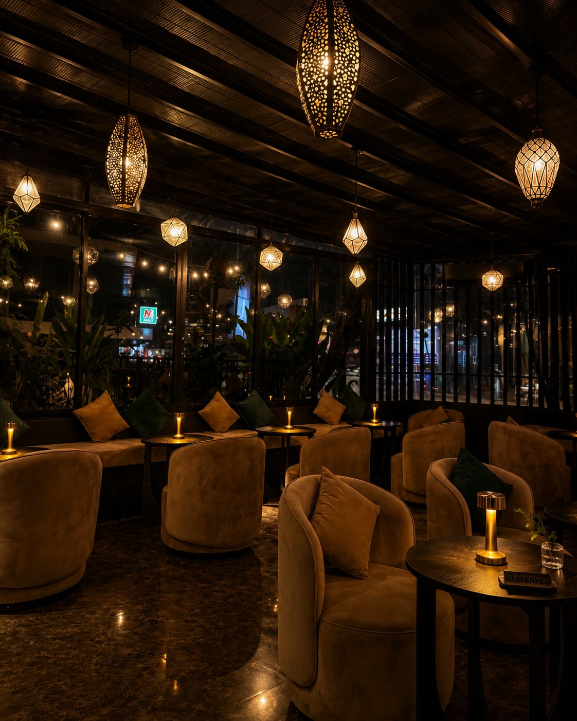 The emerald dining room, lit by brass lanterns